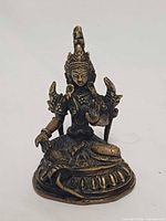 Front view of bronze-brass seated Goddess Tara statue