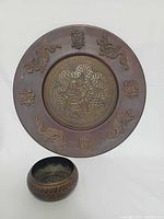 Front of copper dragon plate and singing bowl together