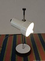 Front angled view of Veneta Lumi table lamp illuminated