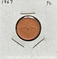 reverse view of coin in holder with rock dove design and dates 1867-1967