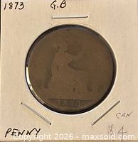 Coin in holder showing Britannia reverse and date