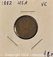 Obverse of 1882 Indian Head cent in cardboard flip, handwritten year and grade visible