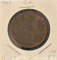 reverse view of coin in holder showing seated Britannia