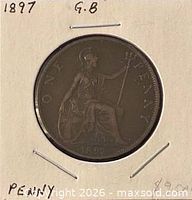 Full view of coin in flip showing reverse with seated Britannia and ONE PENNY legend