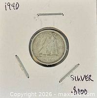 Front of coin in flip showing Bluenose schooner and date 1940
