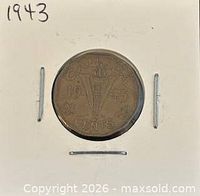 Coin in flip showing reverse V Victory torch design