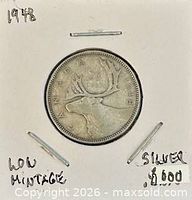 Coin in cardboard flip showing reverse caribou design and handwritten notes