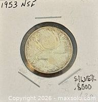 Full view of reverse caribou side in holder with NSF notation and silver content marked