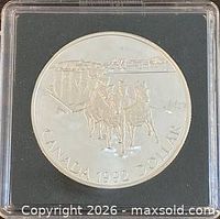 Obverse side with stagecoach design and CANADA 1992 DOLLAR legend