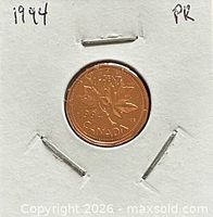 Reverse showing 1994 date, maple leaf design, cardboard holder