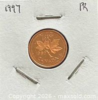 Reverse of 1997 Canadian one-cent coin showing maple leaves and date
