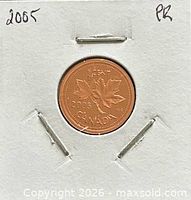 Coin reverse in cardboard flip, maple leaves design, date 2005 visible