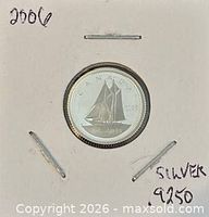 Coin in 2×2 holder showing reverse Bluenose schooner