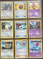 Front view of all nine Pokémon cards laid out in 3×3 grid