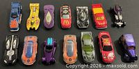 All fourteen Hot Wheels vehicles arranged in two rows