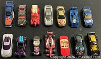 Full lot of 14 Hot Wheels cars arranged in two rows
