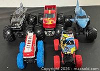 Front view of all five monster trucks