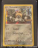 Front of Melmetal card showing artwork, HP, attacks and set logo