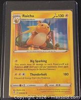 Front view of Raichu 050/203 card in protective sleeve
