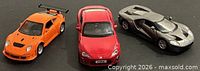 Group shot of three die-cast cars: Porsche 911 GT3 RS, Scion FR-S, Ford GT