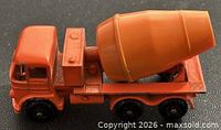 Left side view of orange Matchbox Foden cement mixer showing body, drum and wheels