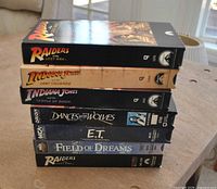 Stack of seven VHS tapes showing spines and titles