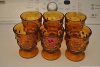 Front view of six amber goblets
