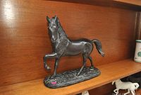 Full view of Ethan Allen metal horse figurine on shelf