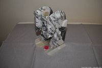 Front angled view of both onyx horse head bookends with sticker visible