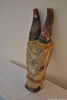 Front angled view of full carved wooden donkey mask