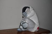 Left-front view of Lladro seated child porcelain figurine