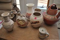 All seven ceramic items on tabletop, clear view of shapes and designs
