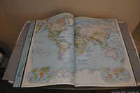 Open atlas displaying world map spread