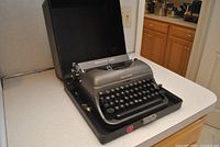 Typewriter in open carrying case angled view