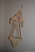 Full view of seashell mobile hanging on wall