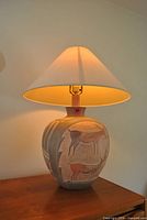 Full view of lamp lit on wooden surface