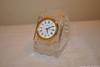 Front view showing crystal body, gold-tone bezel and dial