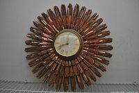 Full view of Syroco sunburst wall clock showing overall design and finish
