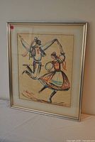 Front view of framed artwork showing folk dancers