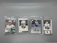 Front view of all four Auston Matthews cards in sleeves