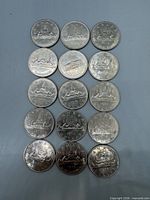 All 15 Canadian dollar coins laid out, obverse visible