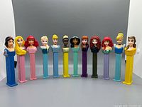 Front view of all twelve Disney Princess PEZ dispensers