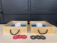 Both wooden target boxes open with washers visible