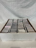 Three-row storage box filled with hockey cards