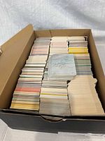 Open shoebox filled with stacked baseball cards