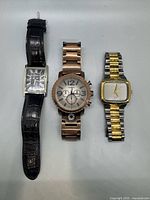 Front view of all three watches showing faces, straps and bracelets