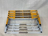 Front view of four stacked Nashville Predators license plate frames