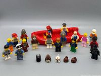 Group shot of 18 minifigures, red boat, spare headgear