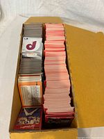 Top view of open box showing two columns of stacked trading cards, left grey-border, right red-border