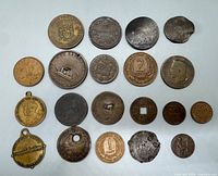 Front view of 20 assorted coins and tokens laid out in four rows of five